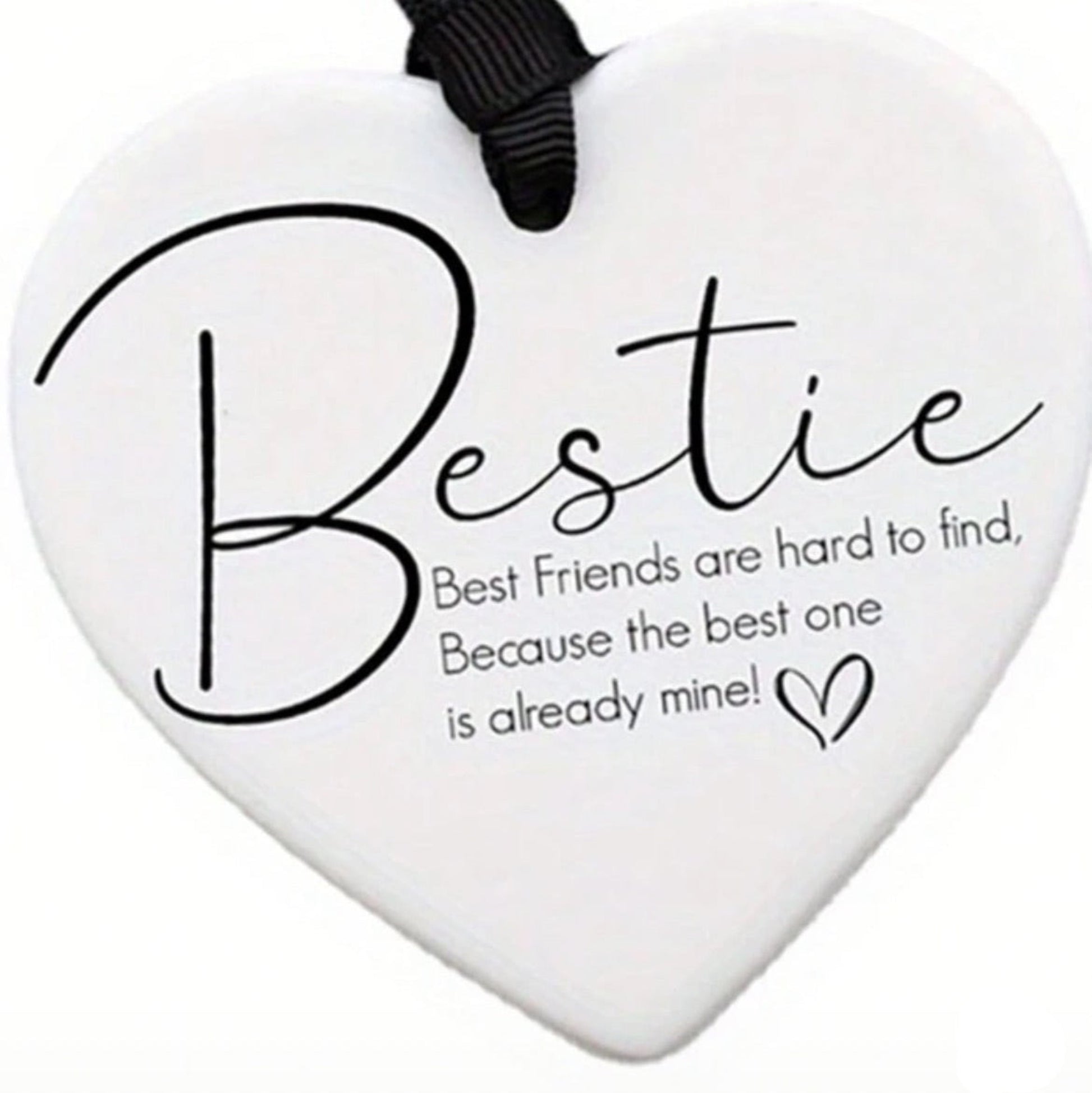 Heart-shaped white plaque with 'Bestie' text and a black ribbon on a white background