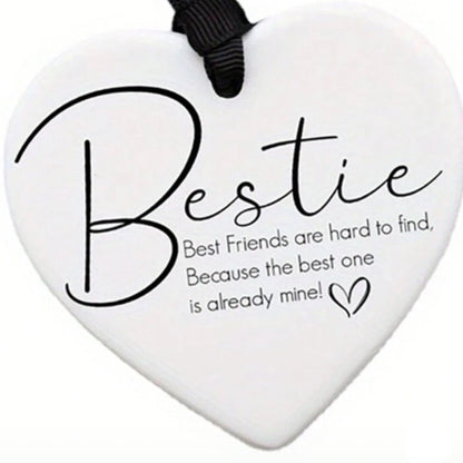 Heart-shaped white plaque with 'Bestie' text and a black ribbon on a white background