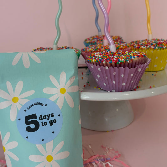 Countdown timer with flowers and a cake in the background