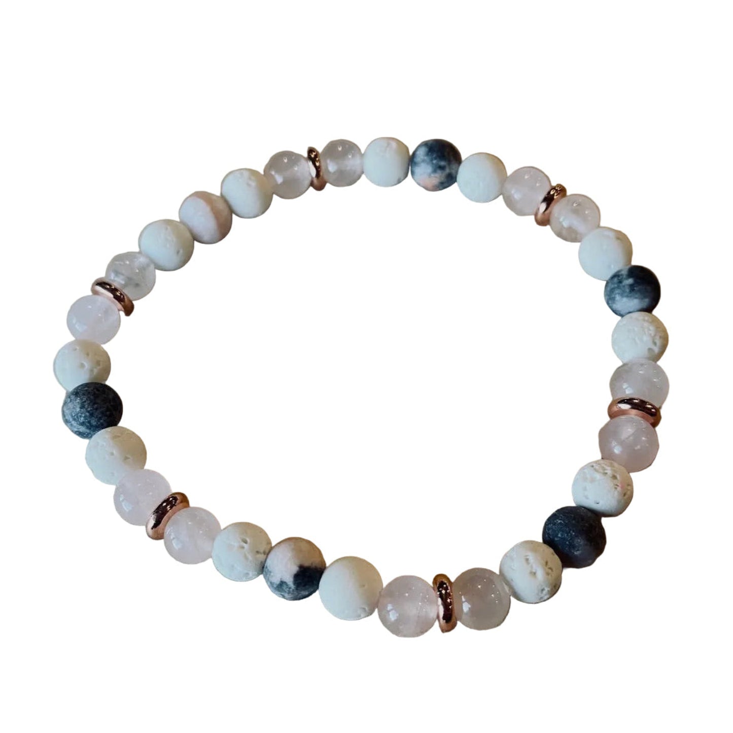 Beaded bracelet with white, black, and rose gold accents on a wooden surface