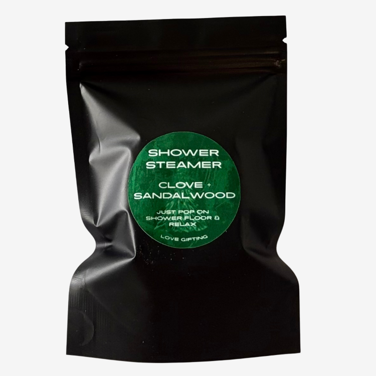 Love Gifting Clove and Sandalwood Shower Steamers in black packaging with green label, refreshing aromatic shower treats for self-care and gifting.