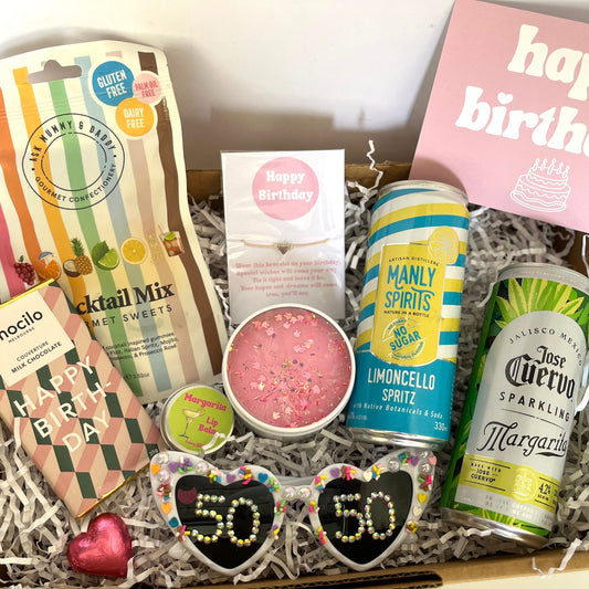 Gift box with birthday-themed items including drinks and snacks.