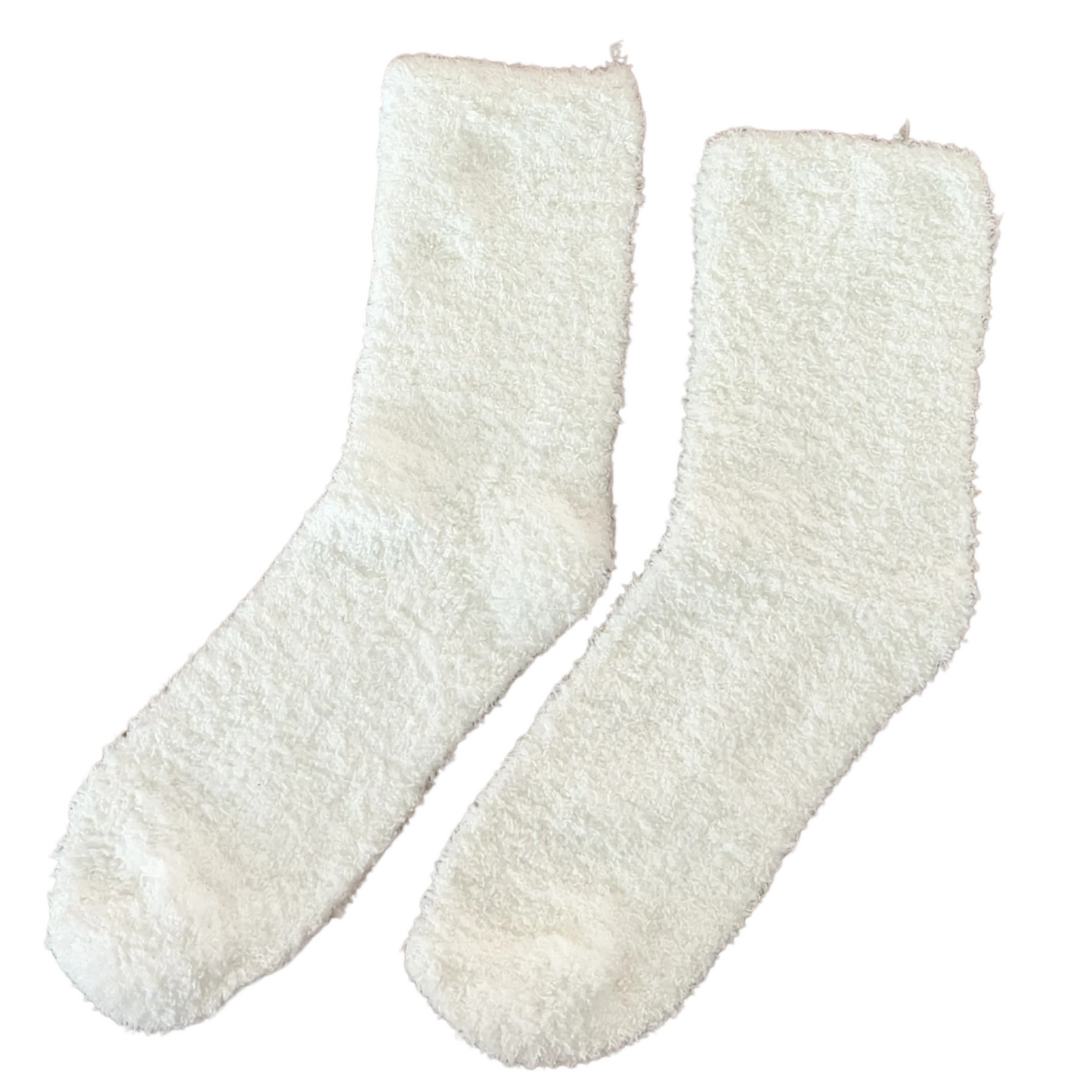 Pair of white fuzzy socks on a pink background