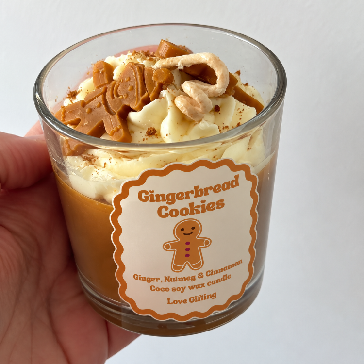 Gingerbread Cookies scented Christmas candle styled with festive gingerbread decorations and cinnamon sticks, featuring a 150g coconut soy wax candle.