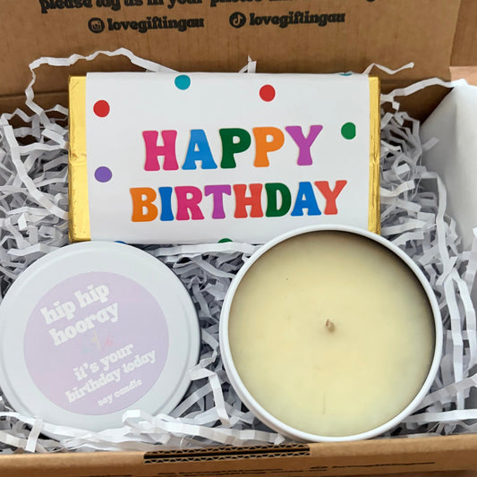 Gift box with a candle, and chocolate bar