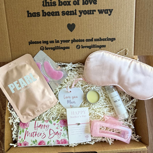 Box of mothers day elf-care items with a message on a wooden surface