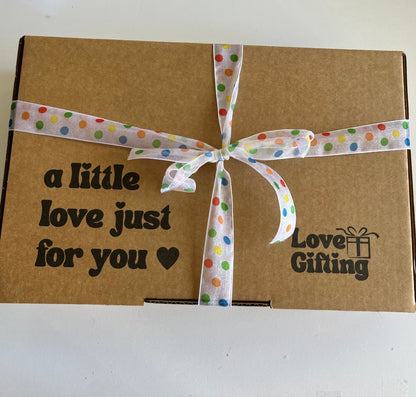 Brown gift box with a polka dot ribbon and 'Love Gifting' text on a white background
