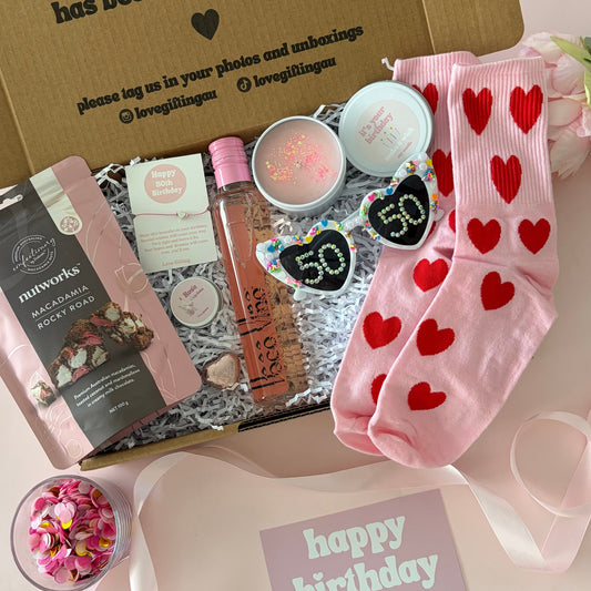 50th rose wine gift box, includes rocky road, lipbalm, bracelet , candle and socks