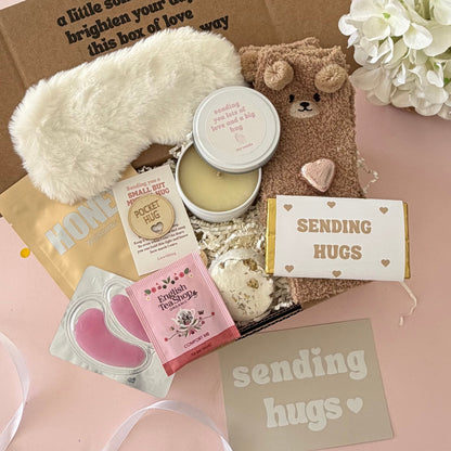Sending Hugs Gift Box including candle, bear socks, lapcos facemask sheet, teabag, under eye, choc heart. shower steamer , pocket hug and Sending Hugs Chocolate
