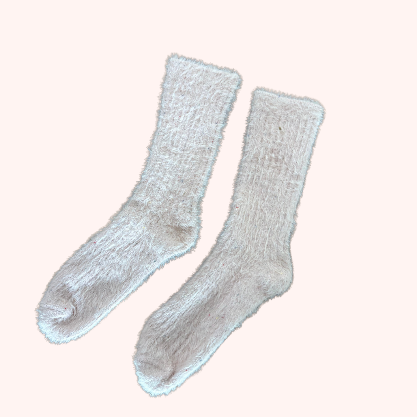 Pair of light pink socks on a white background