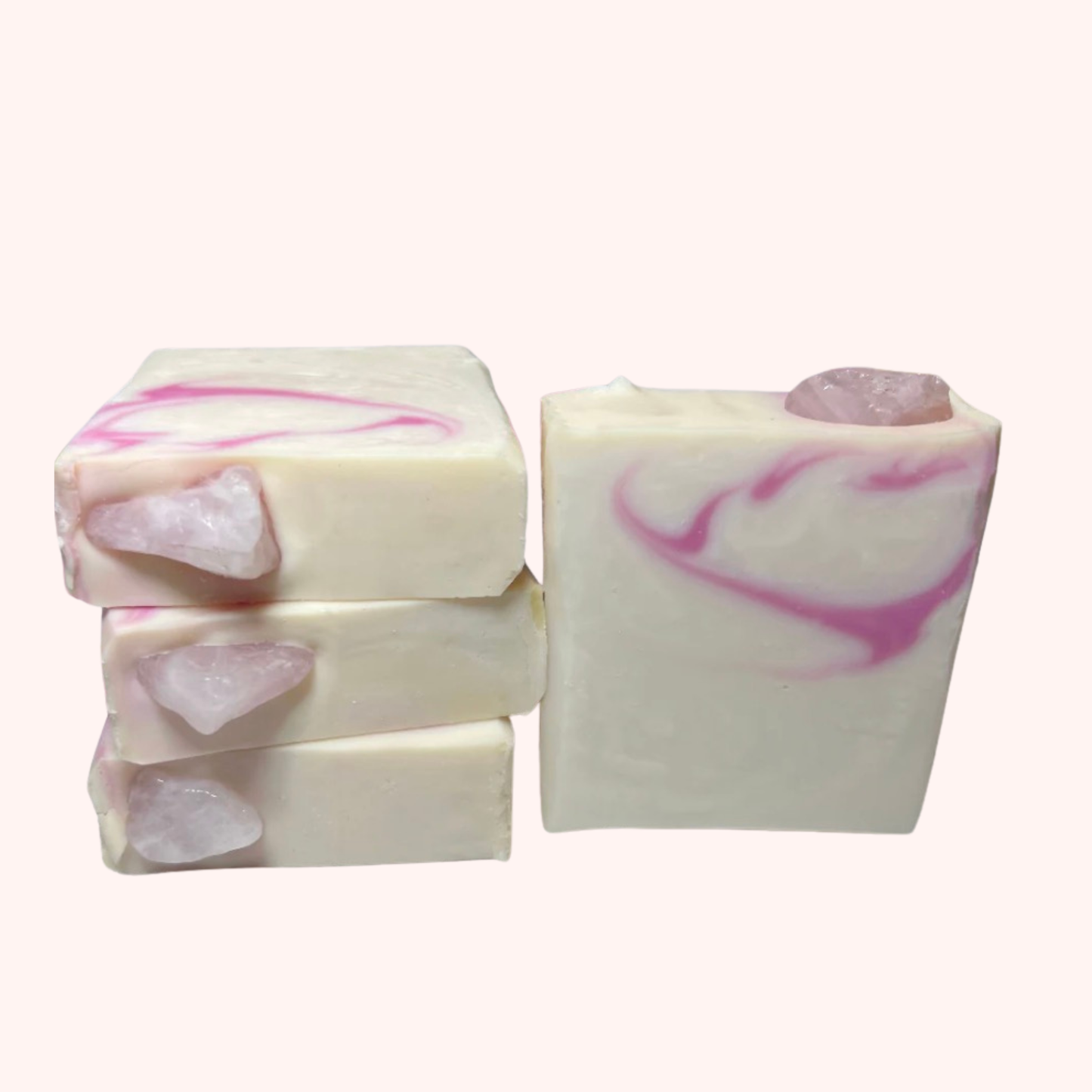 Three bars of soap with pink and white swirls on a white background