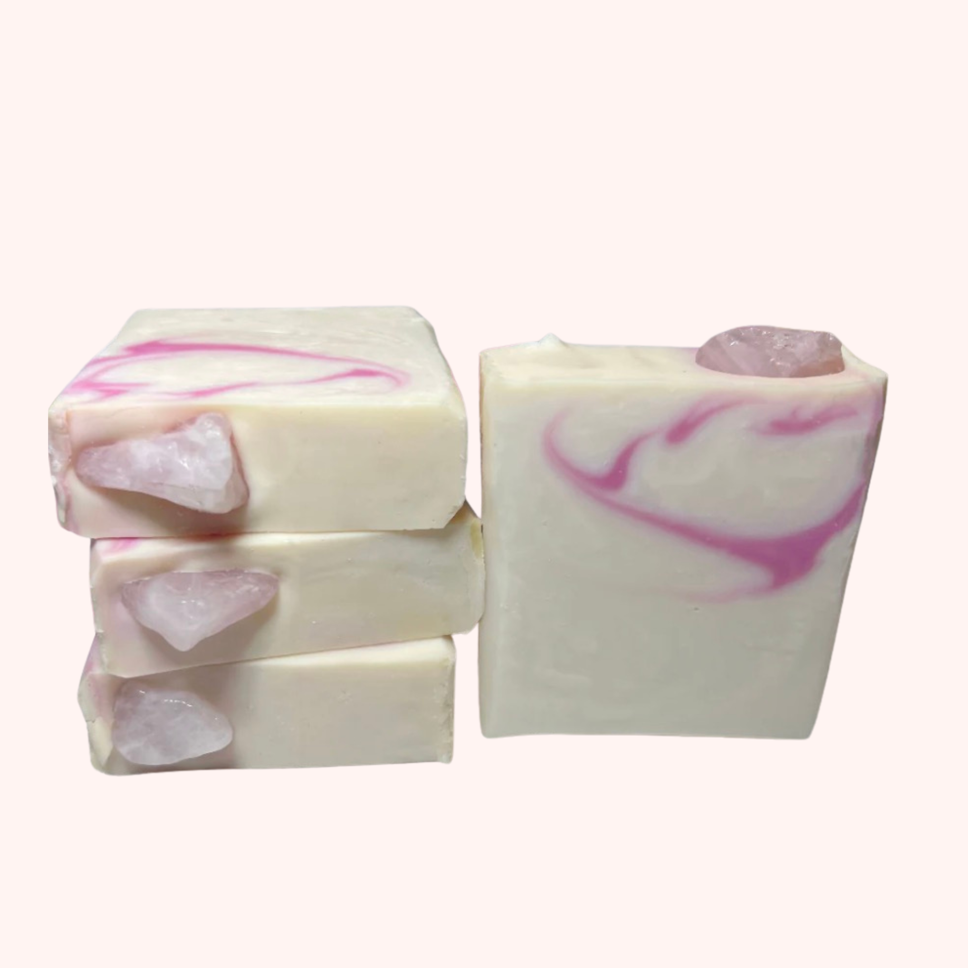 Three bars of soap with pink and white swirls on a white background