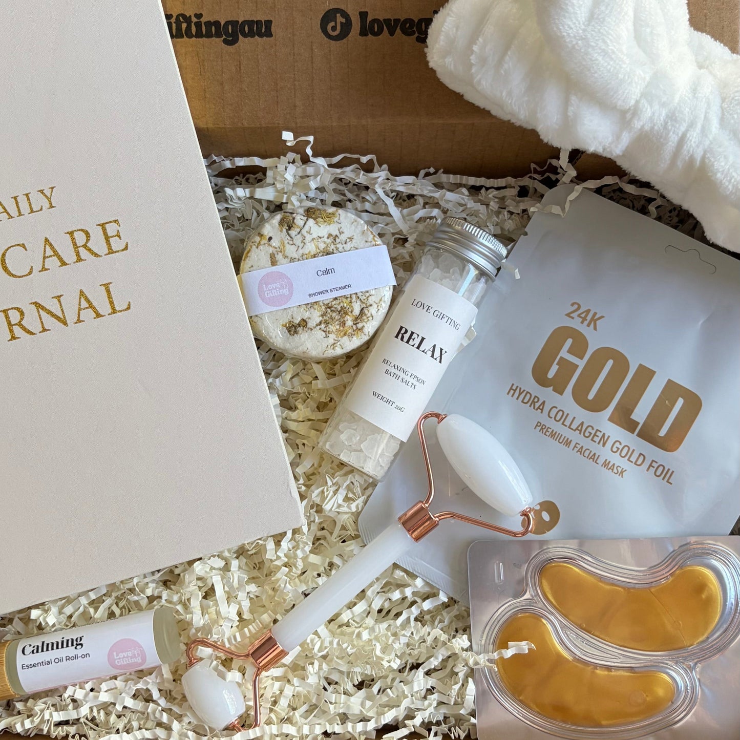 Unboxing of a beauty product set with a 'Gold' product and other items in a box.