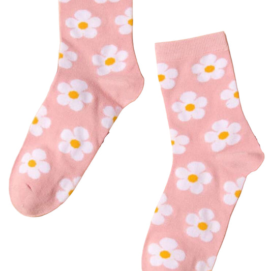 Pink socks with white daisy patterns on a beige background