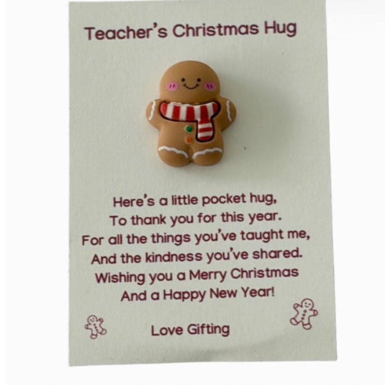 Teacher's Christmas Hug gingerbread pocket hug keepsake featuring a smiling gingerbread character with a red and white scarf on a Christmas thank-you card with a heartfelt poem.