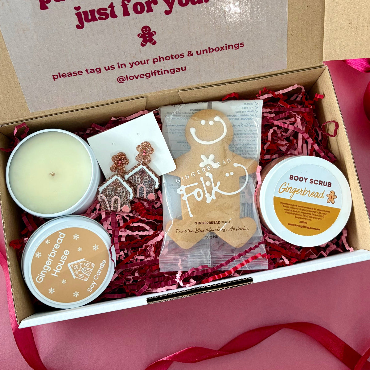 Gingerbread Christmas gift box with gingerbread man, chocolates, gingerbread house candle and body scrub