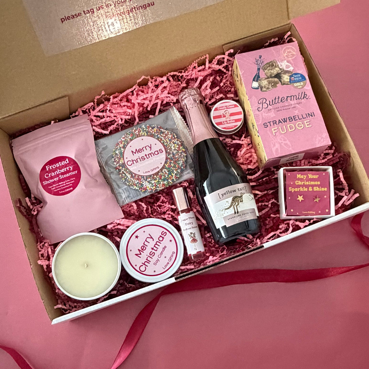 Spoil her with Festive Fizz & Fabulousness, a Christmas gift box with sparkling rosé, Strawberry Bellini fudge, jewellery and pamper treats.
