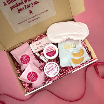 A Moment of Christmas Calm pamper gift box with festive skincare, shower steamers, candle, sleep mask and chocolate
