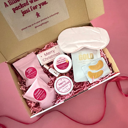 A Moment of Christmas Calm pamper gift box with festive skincare, shower steamers, candle, sleep mask and chocolate