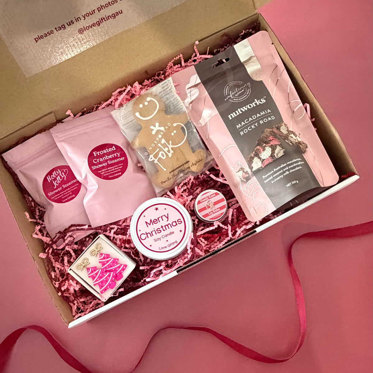 Tis the Season Christmas gift box with pink Christmas tree earrings, gingerbread, candle, Rocky Road and festive pamper treats