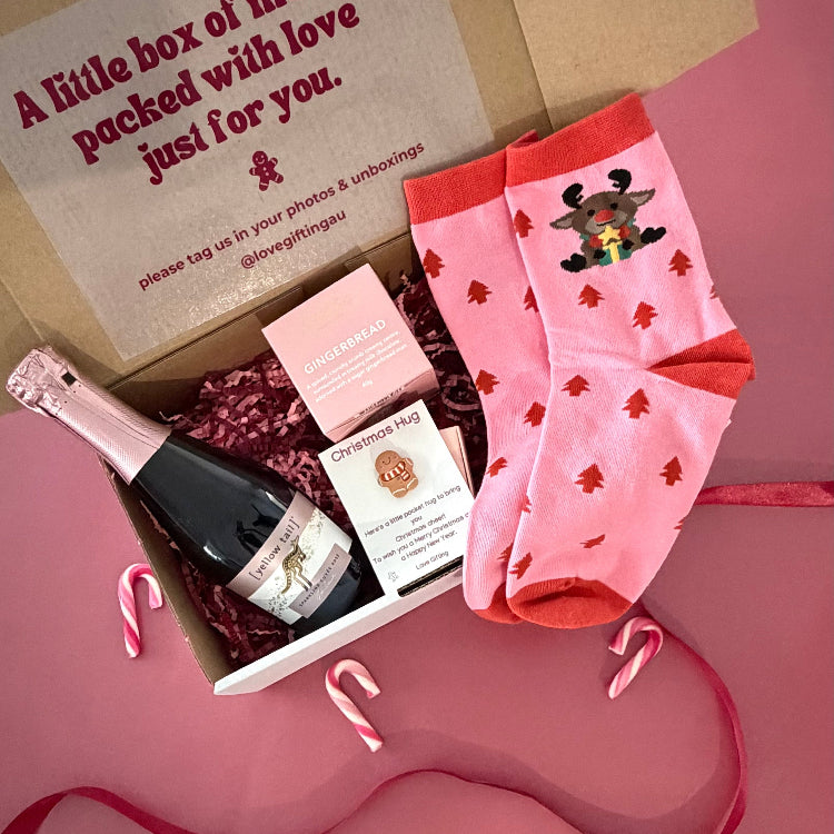 Merry Little Moments Christmas gift box with sparkling rosé, gingerbread chocolates, festive socks and Christmas Pocket Hug