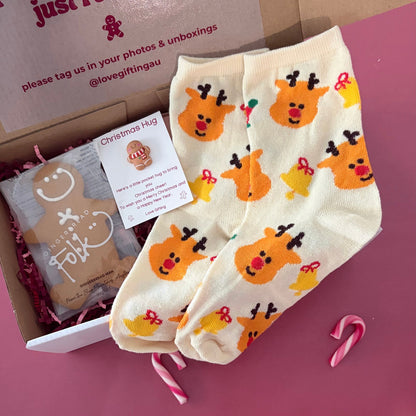 Send a little Christmas hug with festive reindeer socks, a Gingerfolk gingerbread man and Pocket Hug keepsake. Optional gingerbread candle. Shop Love Gifting.