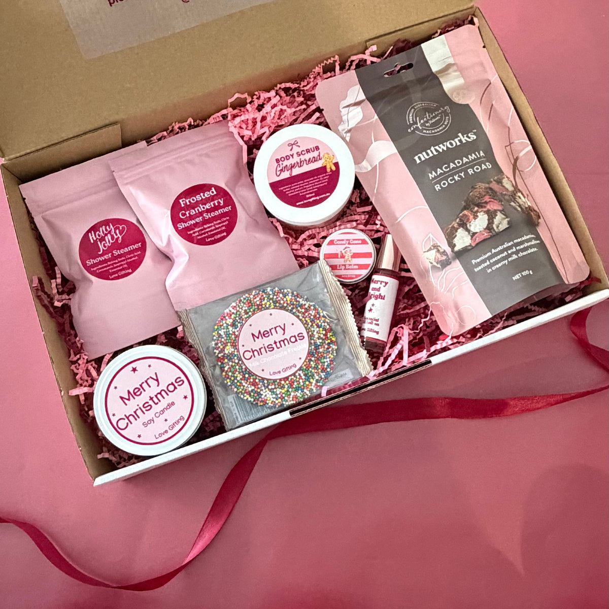 A Moment of Merry Christmas Pamper Gift Box with chocolates, candle, shower steamers and festive self-care treats
