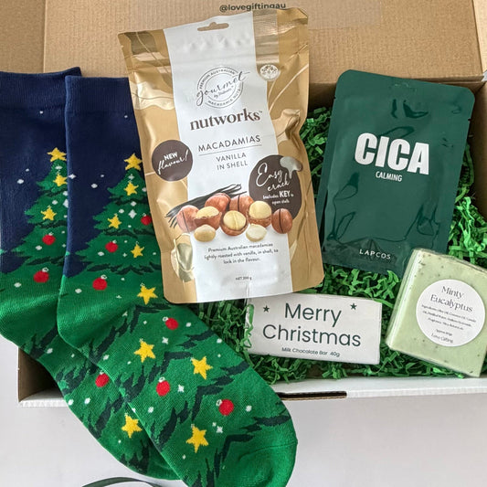 Christmas Crunch & Comfort men's Christmas gift box featuring vanilla macadamias, festive Christmas socks, milk chocolate, Cica face mask and minty eucalyptus soap.